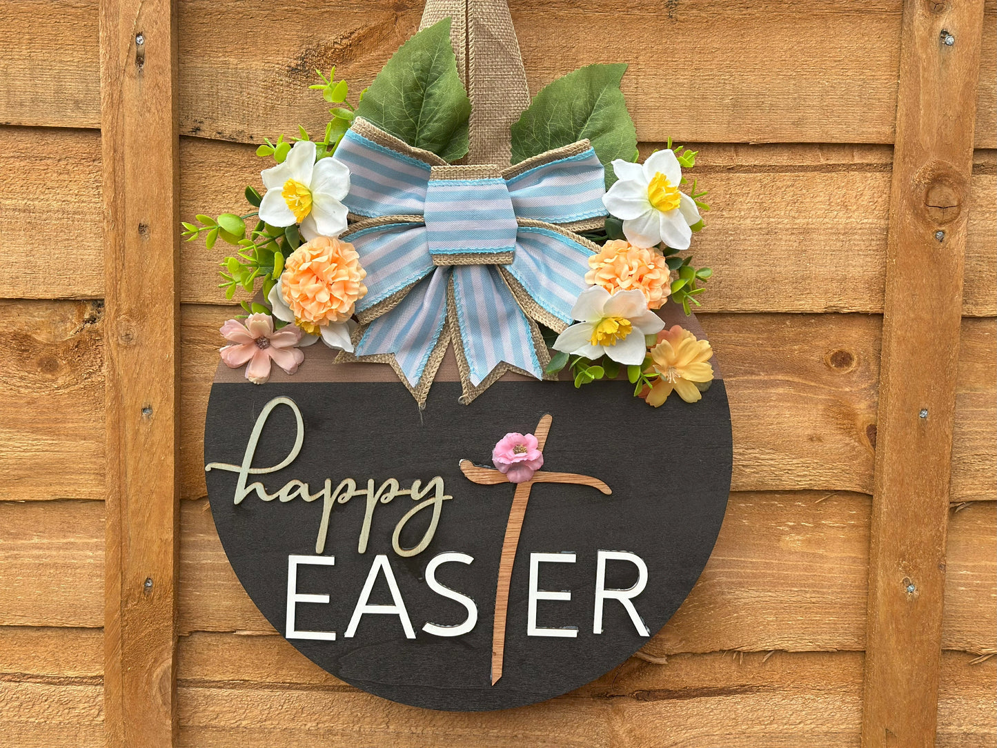 Wooden Easter wreath with pastel floral accents and a striped bow β perfect for festive door decoration