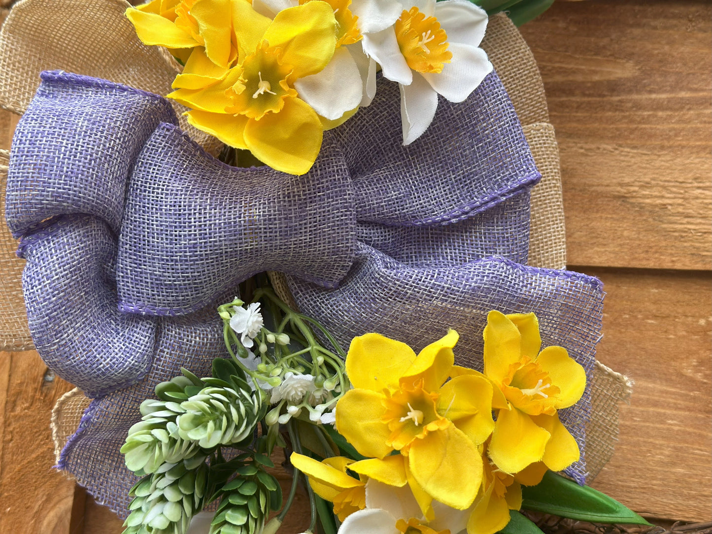 Easter-inspired artificial flower wreath with tulips and daffodils, adding warmth and coziness to your space.