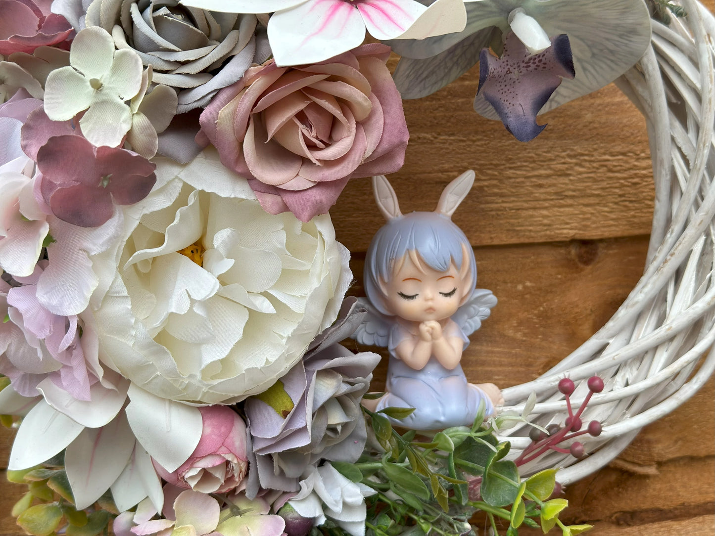 Shabby chic angel wreath with pastel flowers and lush greenery, handcrafted for a delicate and serene touch in your home decor.