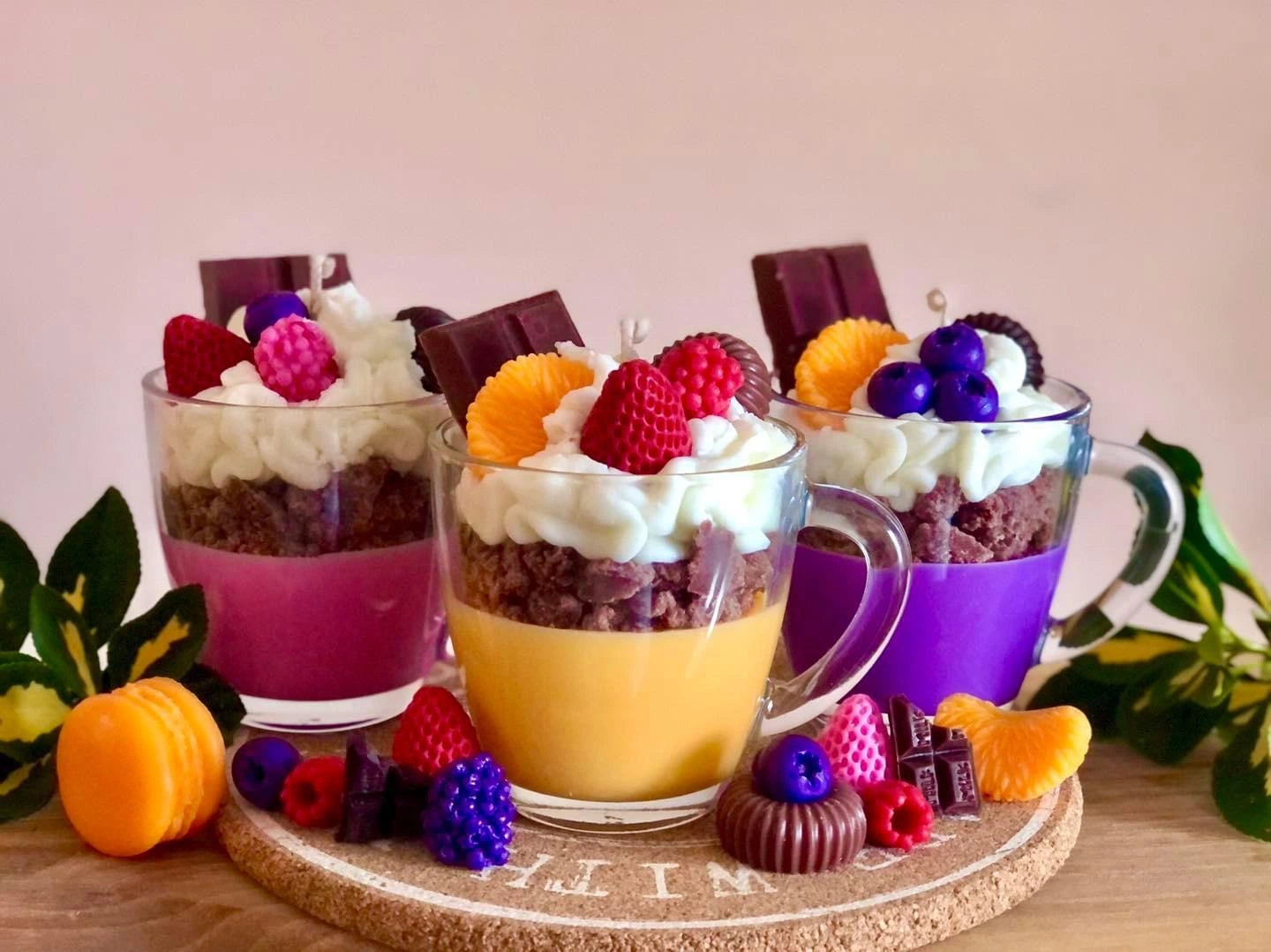 Handmade dessert-inspired scented candles in glass cups, featuring whipped wax, chocolate, and fruit decorations. Luxury soy wax candles for home décor, unique gifts, and long-lasting fragrance.
