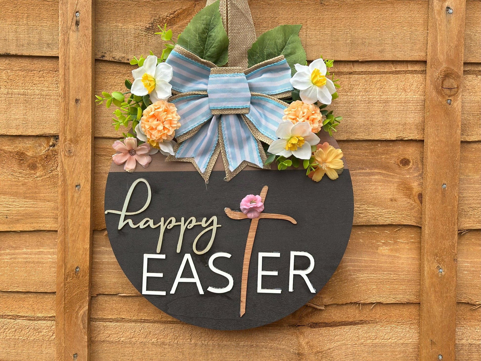 Handmade Easter wreath with artificial flowers and a fabric bow – rustic vintage spring home decor.