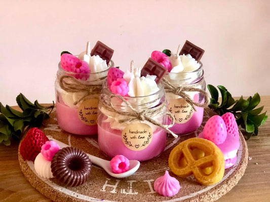 Handmade dessert-inspired scented candles with whipped wax, chocolate, and fruit decorations in glass jars. Luxury soy wax candles for home décor, gifts, and special occasions.